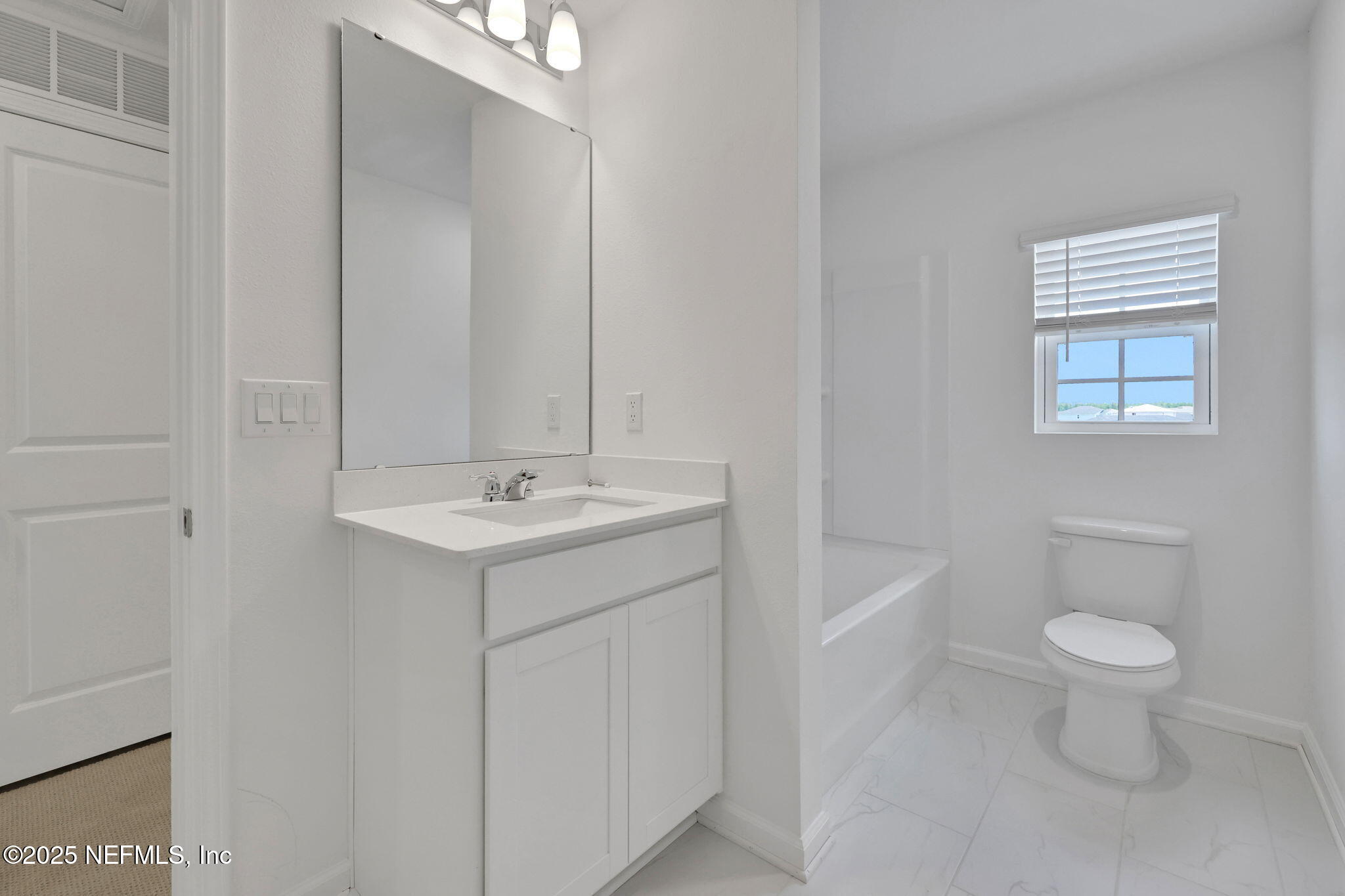 44 Martos Court St. Augustine, FL 32095 - Photo 27 of 40 a bathroom with a toilet a sink a mirror and a bathtub