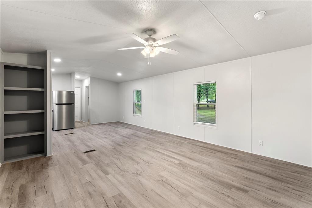 367 Box Road Gun Barrel City, TX 75156 - Photo 6 of 25 a view of an empty room with a window and wooden floor