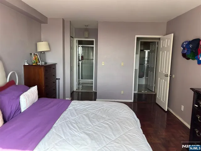 a bedroom with a bed and a potted plant