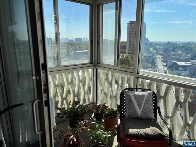 a view of a porch with furniture and wooden floor