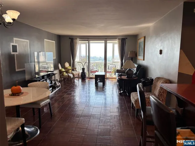 a living room with furniture a rug and a window