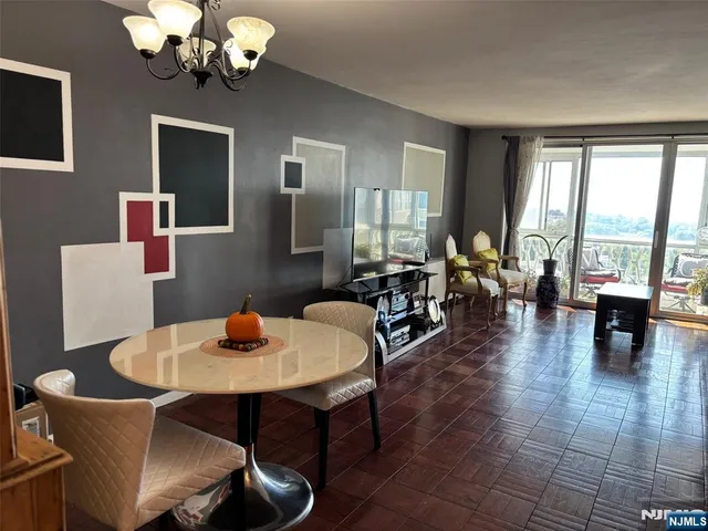 a living room with furniture and floor to ceiling windows