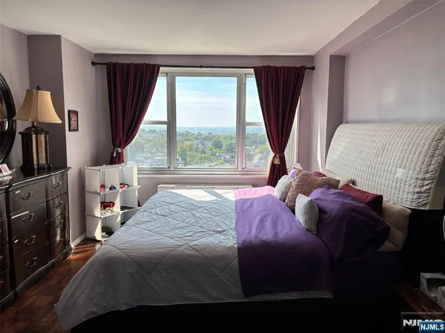 a bedroom with a bed closet and a large window