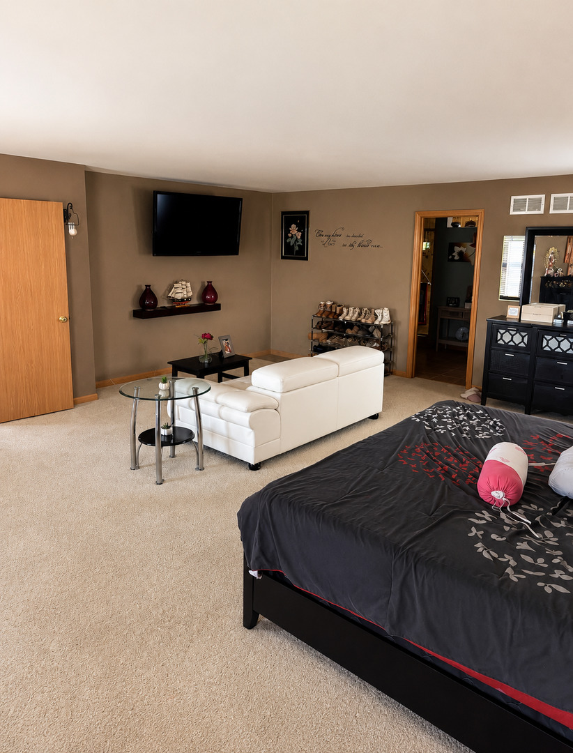 720 Ridge Drive Marengo, IL 60152 - Photo 19 of 34 a bedroom with a bed window and table