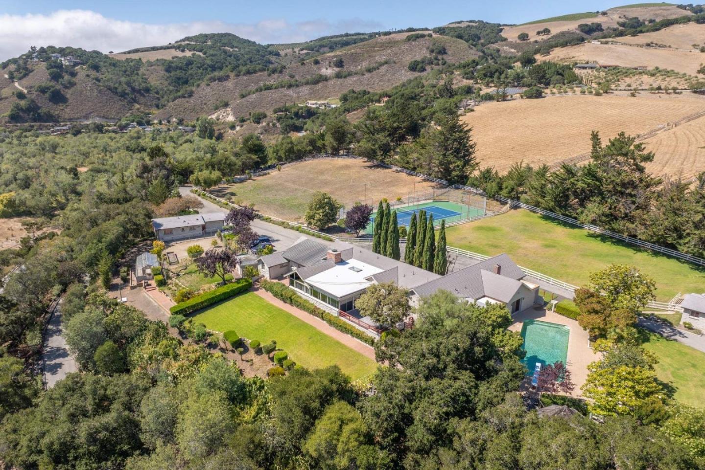 an aerial view of residential houses with outdoor space and river