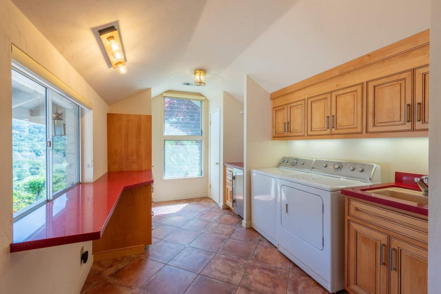 22 Rancho Fiesta Road Carmel Valley, CA 93924 - Photo 13 of 44 a kitchen that has a sink wooden cabinets and a window