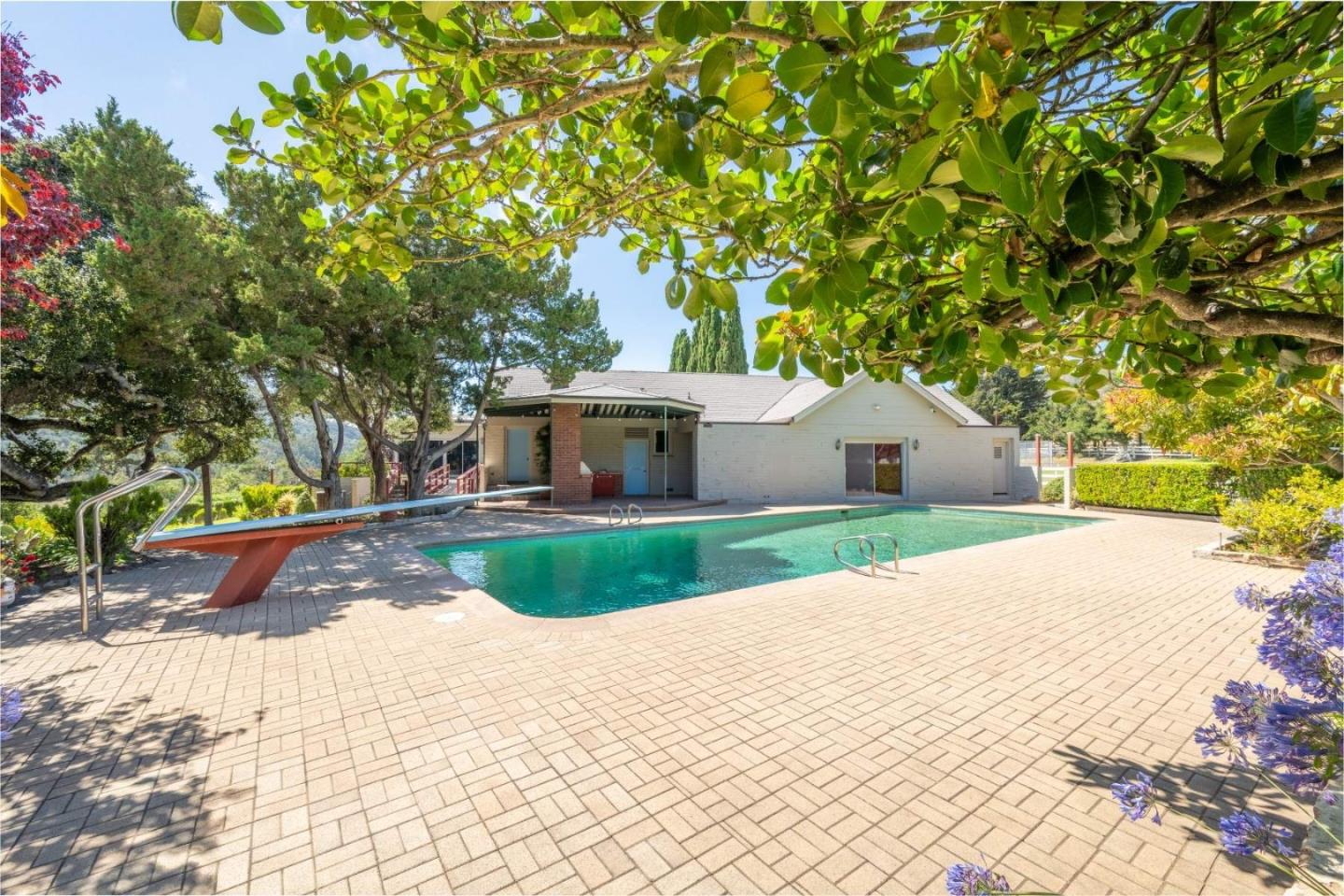 22 Rancho Fiesta Road Carmel Valley, CA 93924 - Photo 19 of 44 a front view of a house with a yard and a garden