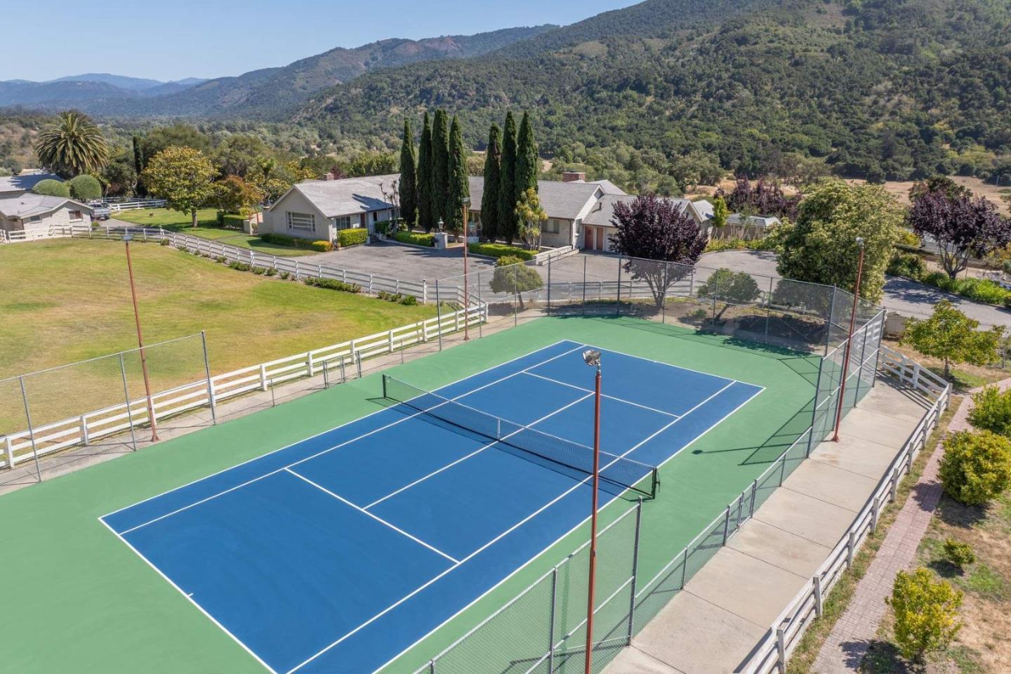 22 Rancho Fiesta Road Carmel Valley, CA 93924 - Photo 2 of 44 a view of a tennis court with a swimming pool