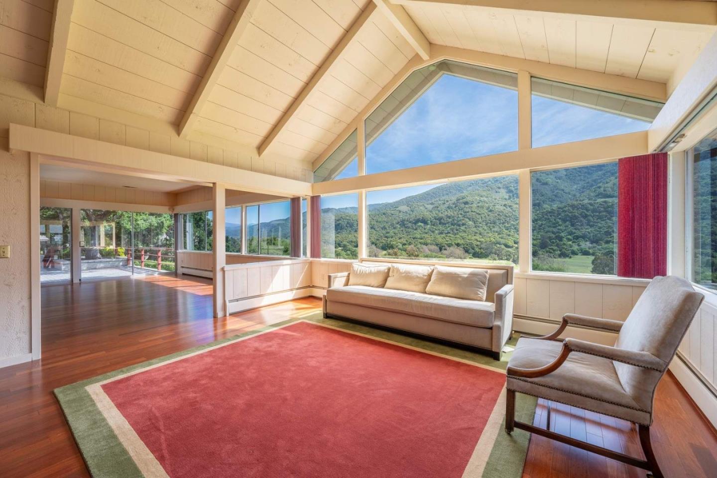 22 Rancho Fiesta Road Carmel Valley, CA 93924 - Photo 24 of 44 a living room with furniture and floor to ceiling windows