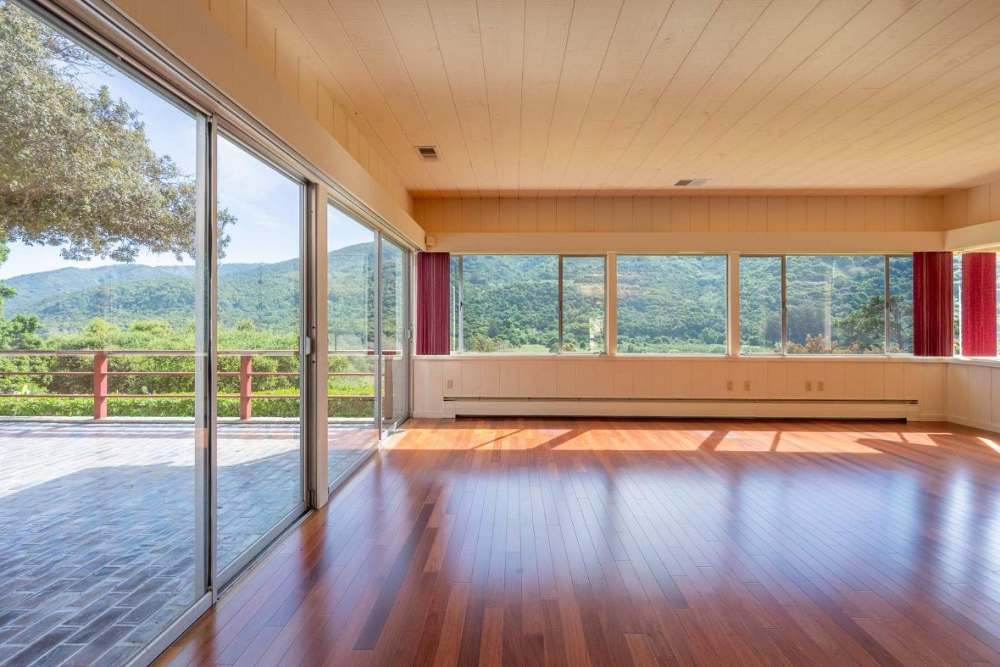 22 Rancho Fiesta Road Carmel Valley, CA 93924 - Photo 25 of 44 a view of empty room with wooden floor and floor to ceiling window