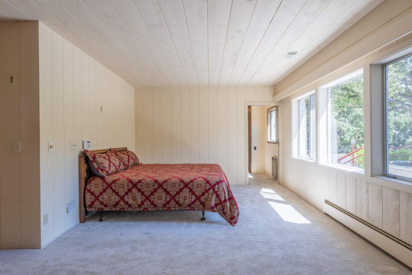 22 Rancho Fiesta Road Carmel Valley, CA 93924 - Photo 32 of 44 a spacious bedroom with a bed and a large window