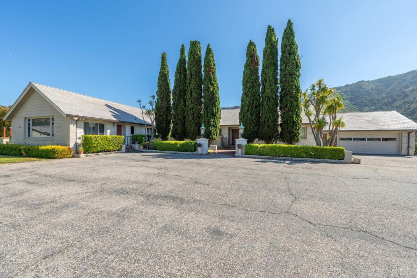 22 Rancho Fiesta Road Carmel Valley, CA 93924 - Photo 6 of 44 a front view of a house with garden and trees