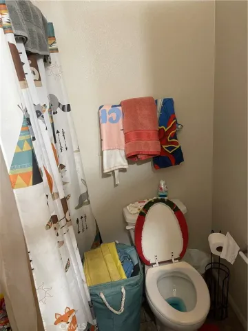 a bathroom with a toilet mirror and tub
