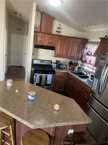 a kitchen with stainless steel appliances granite countertop a sink stove and cabinets