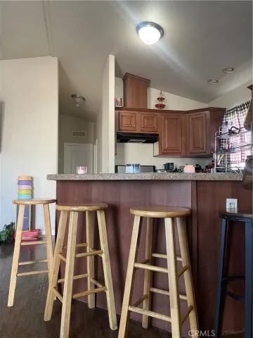 a kitchen with stainless steel appliances kitchen island granite countertop a sink and cabinets