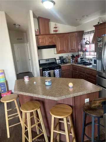 a kitchen with stainless steel appliances dining table and chairs
