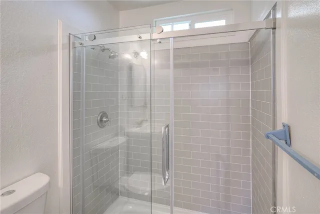 a bathroom with a shower and a toilet