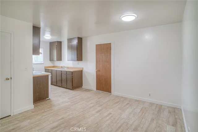 a view of a kitchen with a sink and a refrigerator