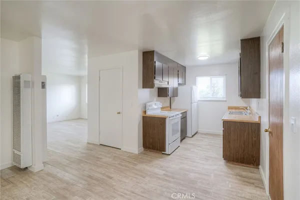 a kitchen with a refrigerator sink and cabinets