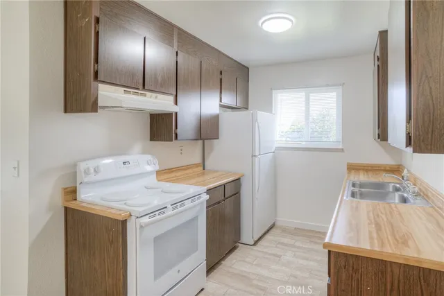 a utility room with cabinets washer and dryer