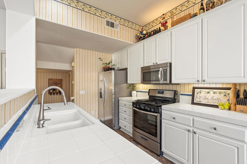 2871 Player Lane Tustin, CA 92782 - Photo 11 of 44 a kitchen with a sink stainless steel appliances a refrigerator and cabinets