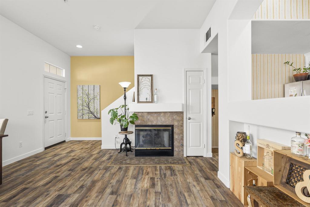 2871 Player Lane Tustin, CA 92782 - Photo 9 of 44 a view of a livingroom with a fireplace a ceiling fan and wooden floor