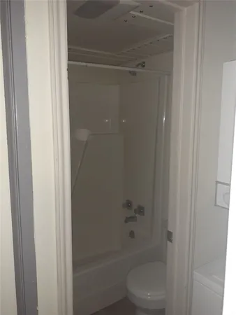 a bathroom with a shower and a toilet