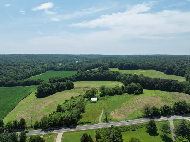 an aerial view of a house with yard