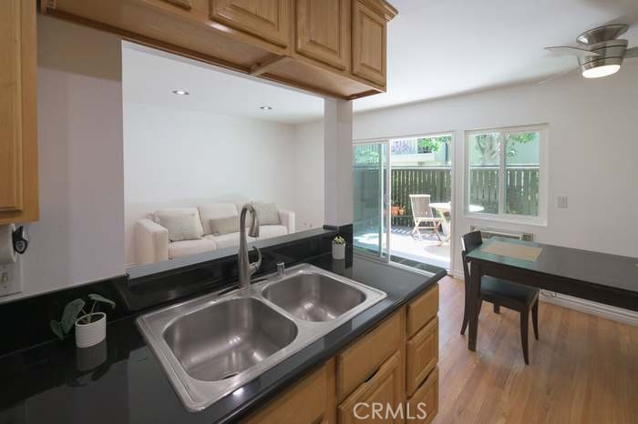 a kitchen with a sink cabinets and wooden floor