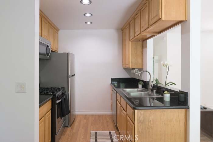 4812 Hollow Corner Road, Unit 151 Culver City, CA 90230 - Photo 2 of 14 a kitchen with stainless steel appliances granite countertop a sink stove and refrigerator