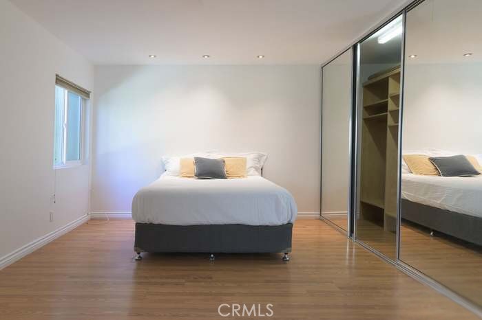 4812 Hollow Corner Road, Unit 151 Culver City, CA 90230 - Photo 7 of 14 a bedroom with a bed and a walk in closet