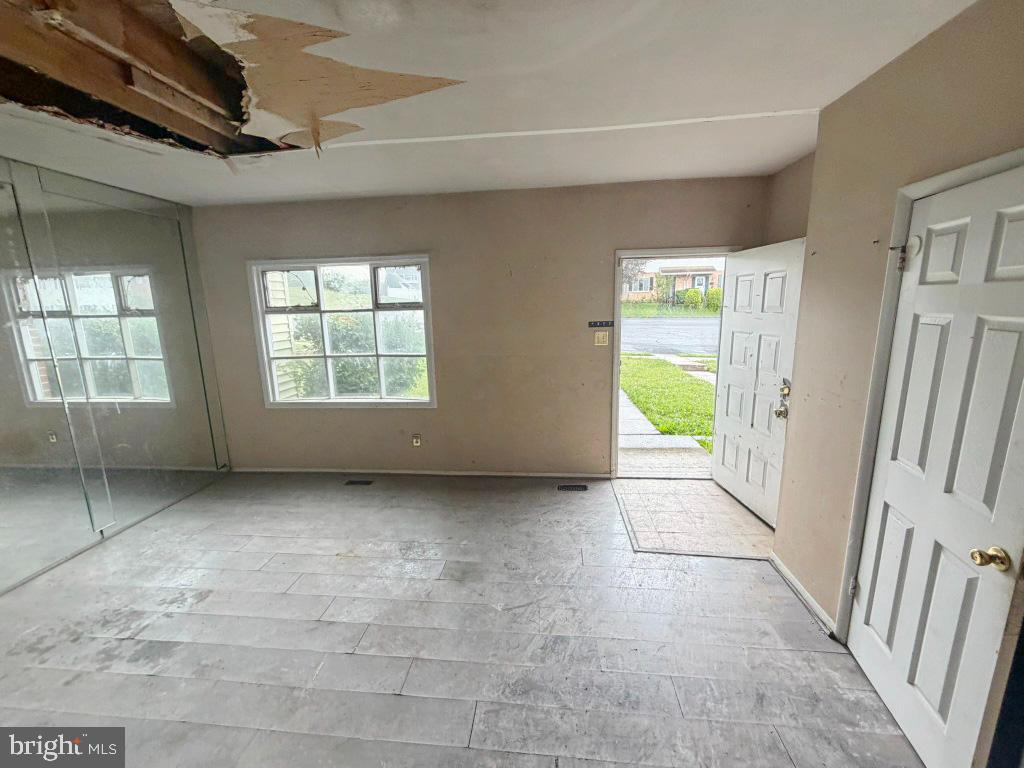 2039 Wintergreen Place Rosedale, MD 21237 - Photo 6 of 46 a view of an empty room with a window and wooden floor