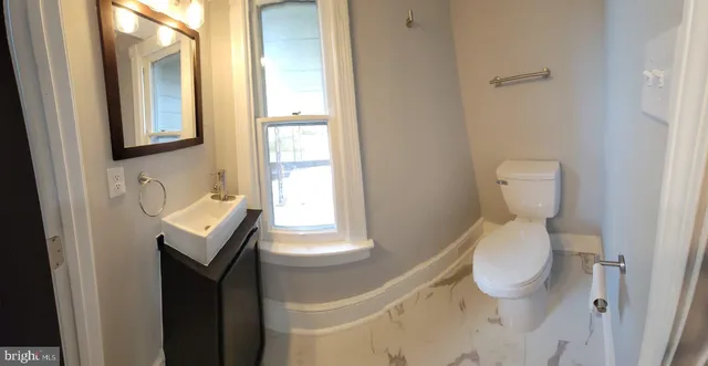 a bathroom with a sink a mirror and a bathtub