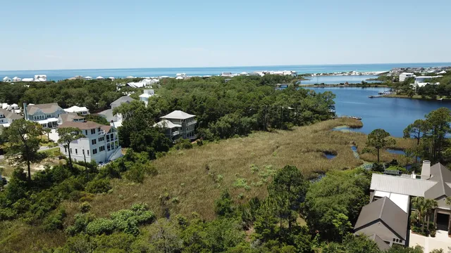 an aerial view of a house with a yard and lake view