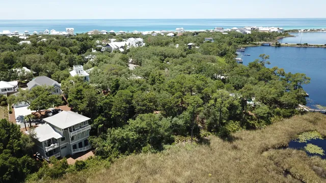 an aerial view of residential house with outdoor space and trees all around
