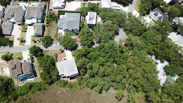 an aerial view of a house with a yard and lake view