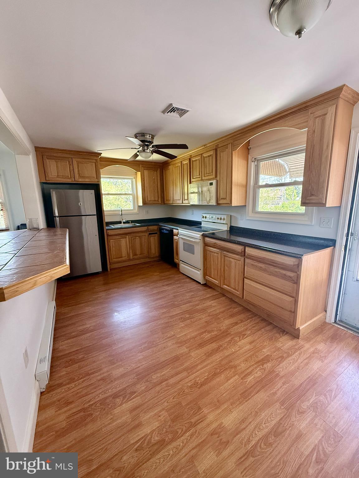5 Copes Lane Media, PA 19063 - Photo 3 of 18 a kitchen with stainless steel appliances wooden floor sink and stove