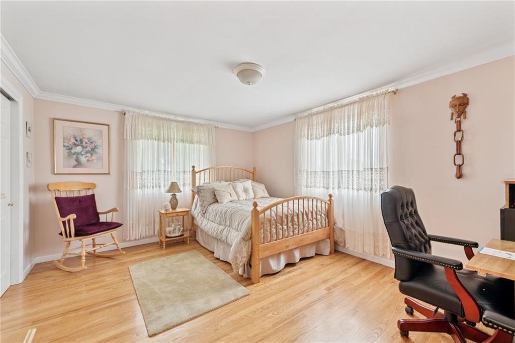 145 Herbst Road Coraopolis, PA 15108 - Photo 23 of 35 a bedroom with a bed and a chair