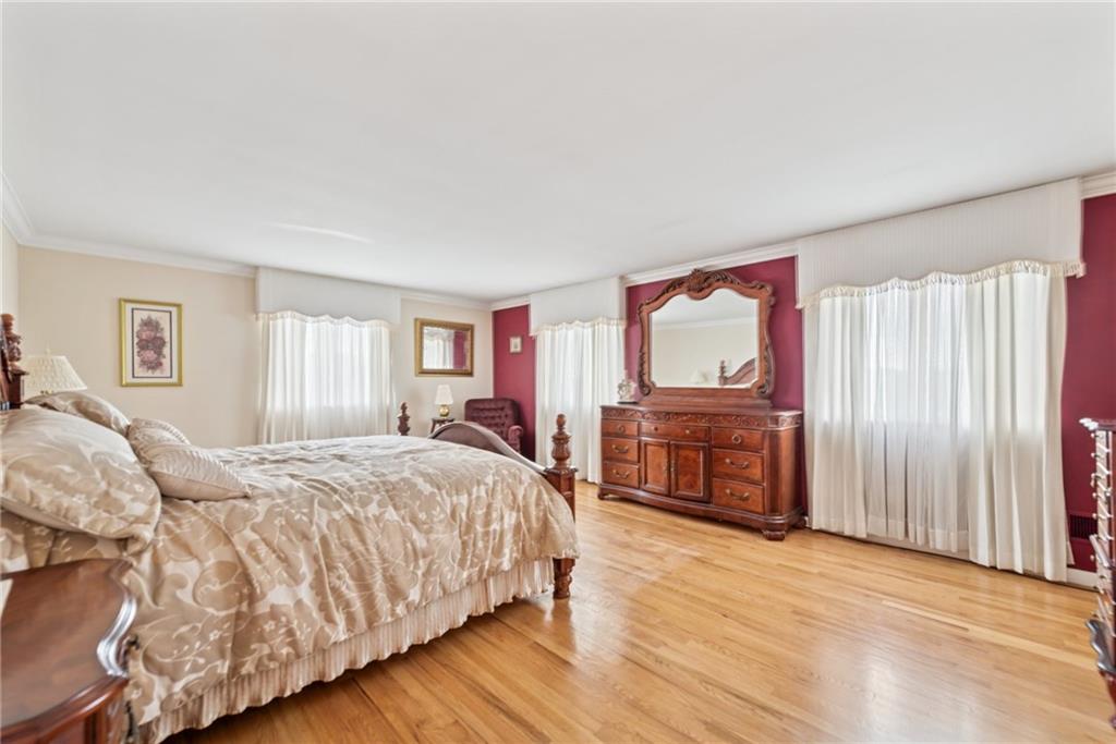 145 Herbst Road Coraopolis, PA 15108 - Photo 25 of 35 a bedroom with a large bed a flat tv screen and dresser