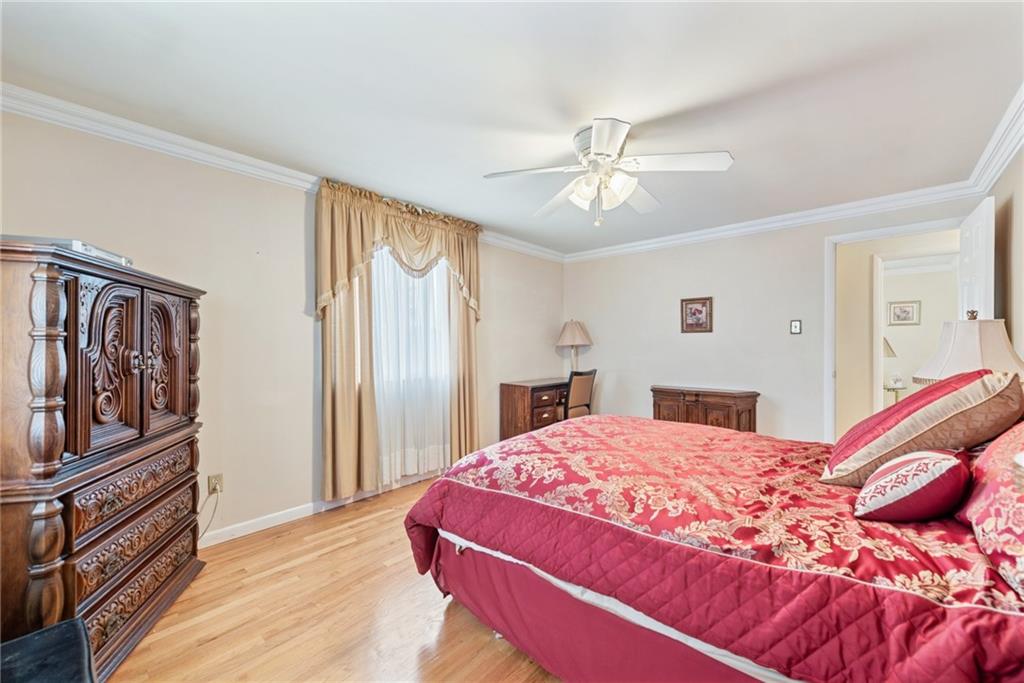 145 Herbst Road Coraopolis, PA 15108 - Photo 27 of 35 a bedroom with a large bed and a chandelier