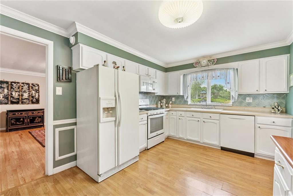 145 Herbst Road Coraopolis, PA 15108 - Photo 8 of 35 a kitchen with white cabinets and white appliances