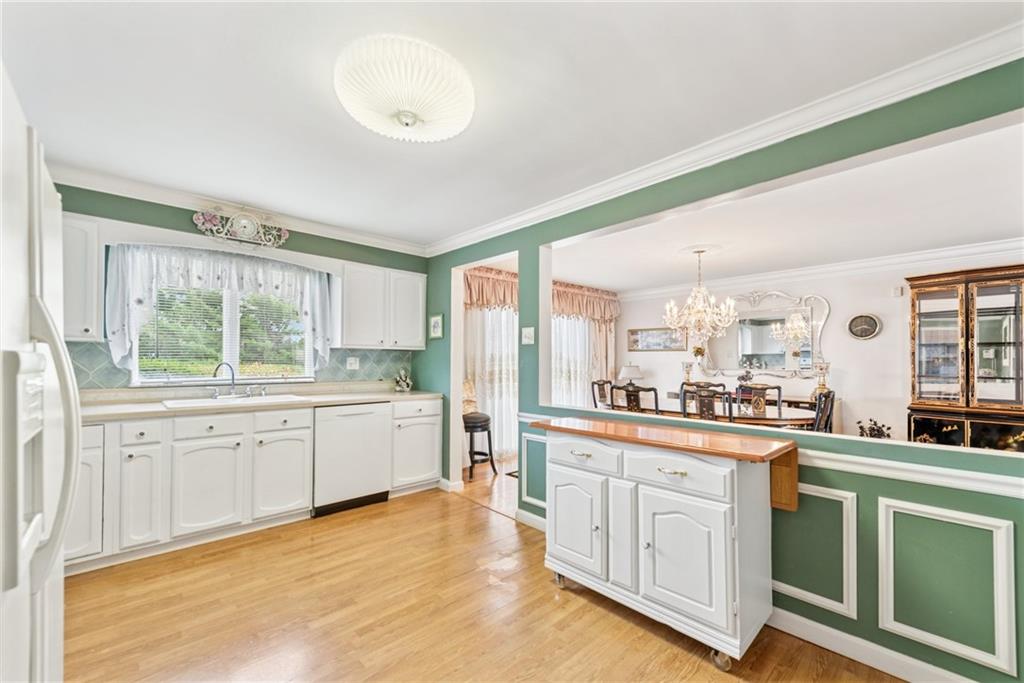 145 Herbst Road Coraopolis, PA 15108 - Photo 9 of 35 a large kitchen with a lot of counter space and a wooden floor