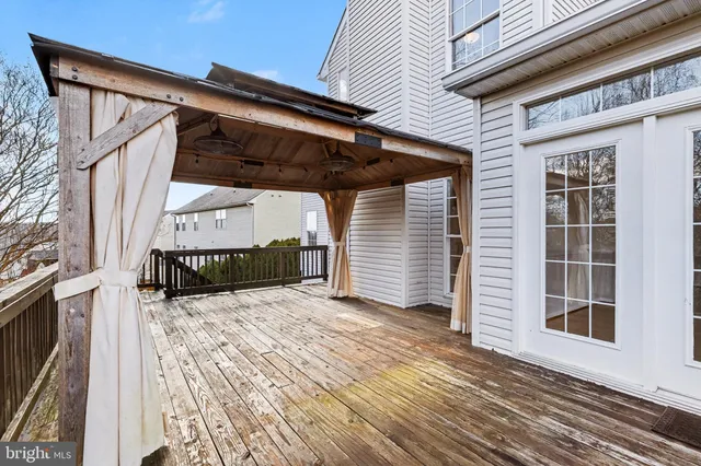 a view of a house with a wooden deck