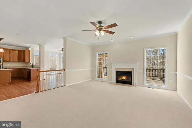 a view of a livingroom with a fireplace and a kitchen