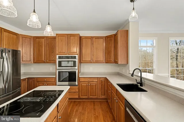 a kitchen with wooden cabinets a stove and a window