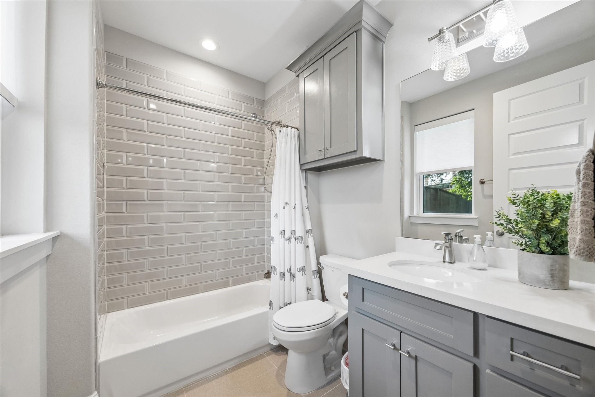 2913 Hicks Street Houston, TX 77007 - Photo 23 of 28 The secondary bathroom is beautifully appointed with quartz countertops, custom cabinetry, and elegant tile finishes for a clean and modern feel.