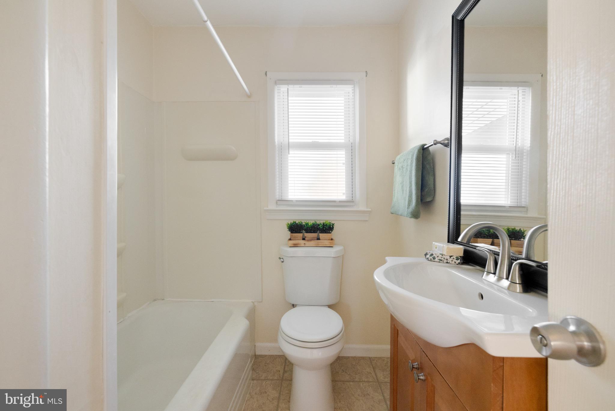 405 East 7th Avenue Ranson, WV 25438 - Photo 13 of 29 a bathroom with a sink toilet and mirror