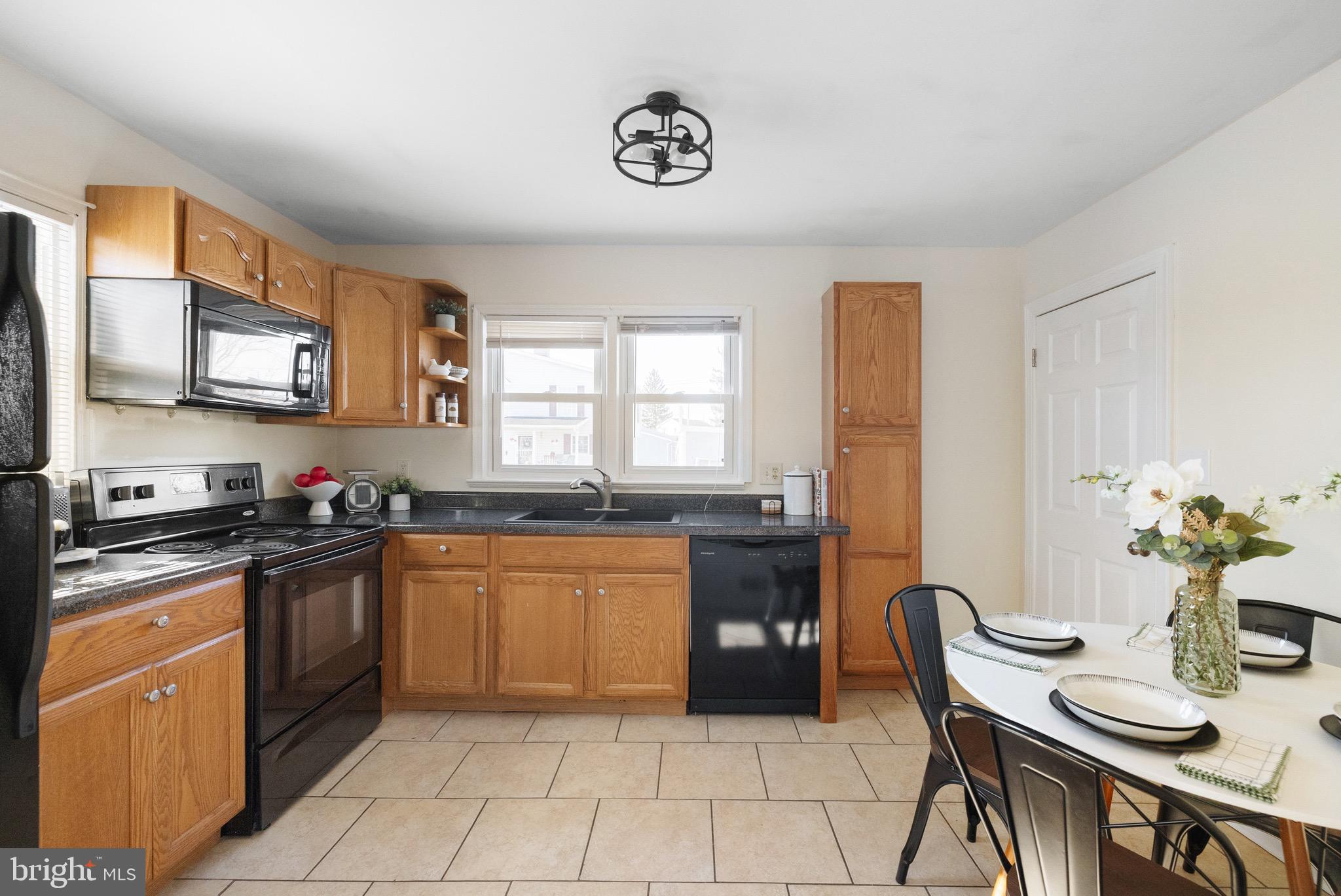 405 East 7th Avenue Ranson, WV 25438 - Photo 6 of 29 a kitchen with granite countertop cabinets a stove a sink and a refrigerator