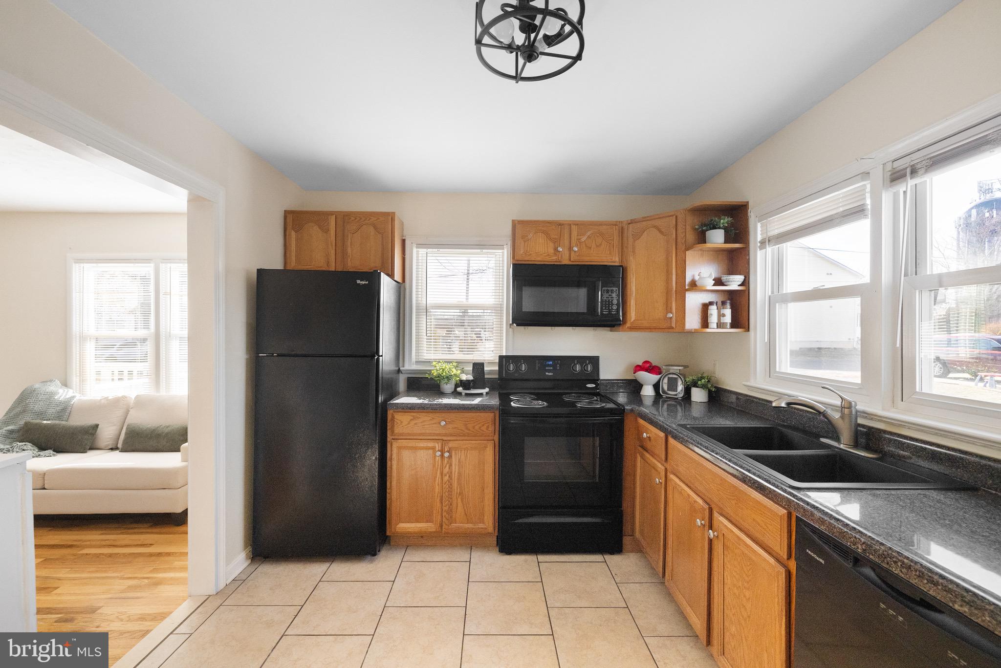 405 East 7th Avenue Ranson, WV 25438 - Photo 8 of 29 a kitchen with a refrigerator a sink and a stove