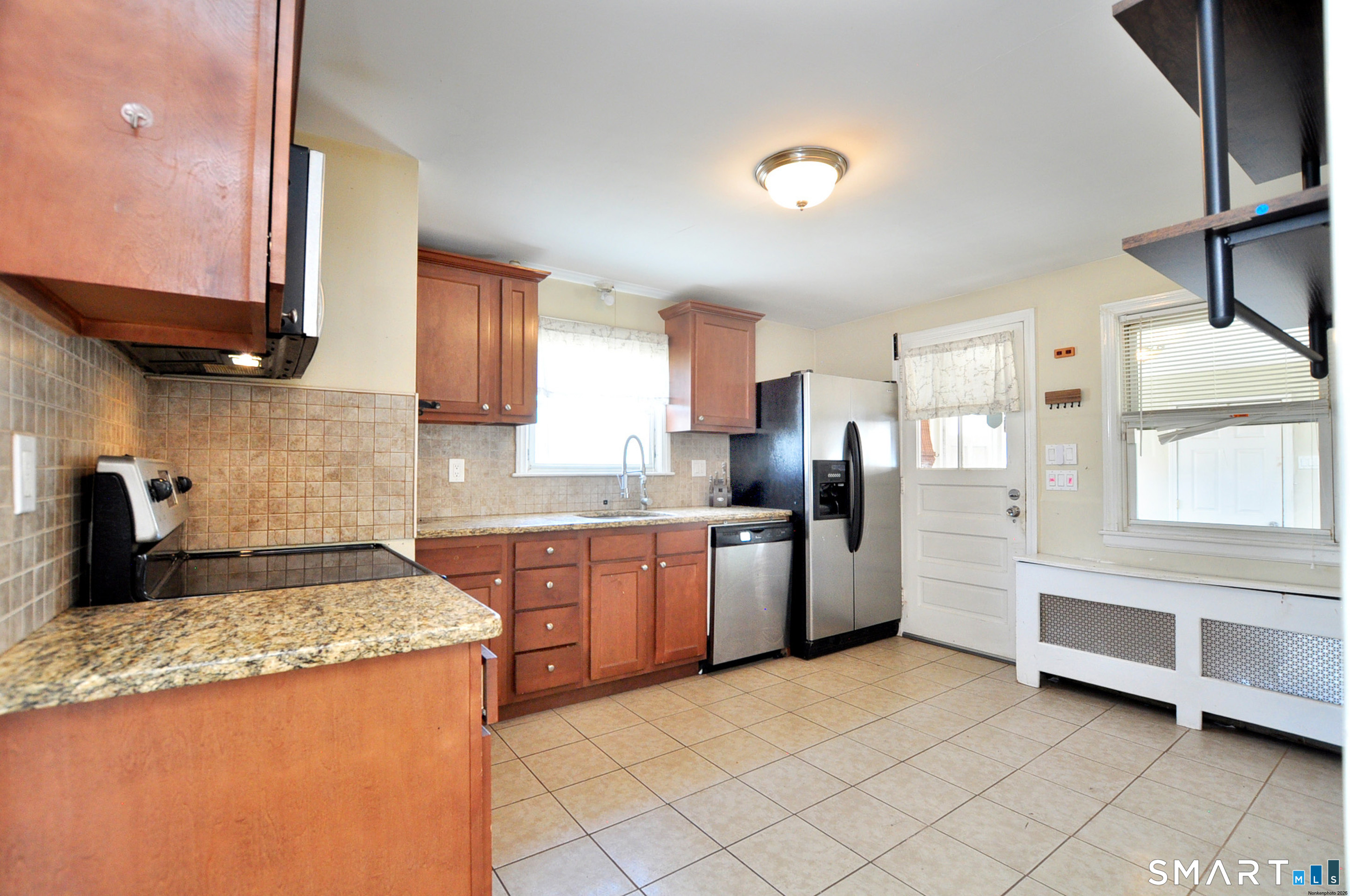 103 West Center Street Manchester, CT 06040 - Photo 16 of 29 a kitchen with granite countertop a sink stainless steel appliances and cabinets